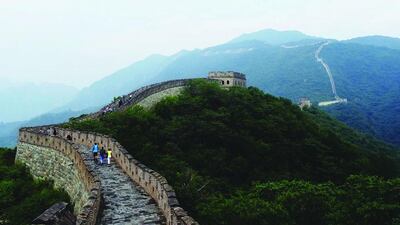 Tourists Walking On Great Wall Of China Against Sky. Getty Images