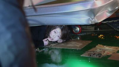 A woman trapped in the rubble of a collapsed resort building waits to be rescued in Gyeongju, South Korea, on February 17, 2014. Police and news reports say dozens of university students are feared trapped after a building’s roof collapsed because of recent heavy snowfall. Lee Sang-hyun / AP photo/Yonhap