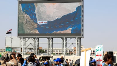 Houthi supporters gather in front of a digital billboard in Sanaa. EPA