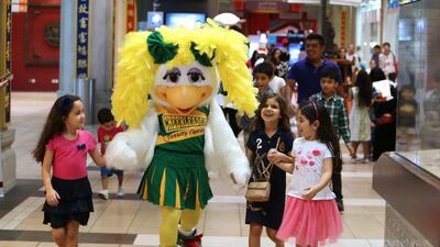 Kids with the mascot of Chuck E Cheese & Friends after their performance at the China Court at Ibn Battuta Mall in Dubai. Pawan Singh / The National