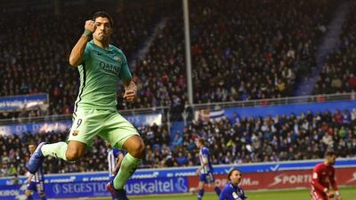 Barcelona’s Luis Suarez, left, celebrates after scoring his goal in front Alaves’s goalkeeper Fernando Pacheco. Alvaro Barrientos / AP Photo