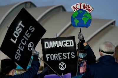 Demonstrators from Extinction Rebellion holds placards at a protest about Loss and Damage to the earth during the COP26. AP