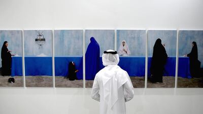 A visitor looks at work by artist Maïmouna Guerresi at Art Dubai. Art purchases began to recover in 2010 and have been growing ever since. Francois Nel / Getty Images for Art Dubai