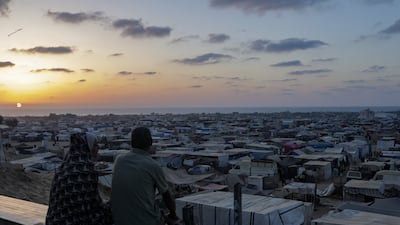 Palestinians who fled Rafah look out over tents for displaced people in Khan Younis, Gaza. EPA