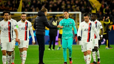 Thomas Tuchel (C-L) shakes hands with PSG goalkeeper Keylor Navas at the end of the match. AFP