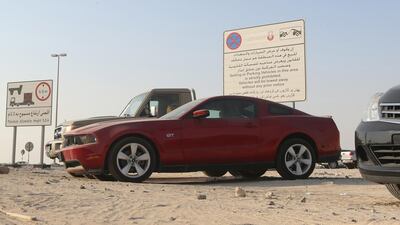 Car sellers are back to illegally parking their cars for sale at the roundabout in Al Shamkha despite postings by the municipality. Delores Johnson / The National