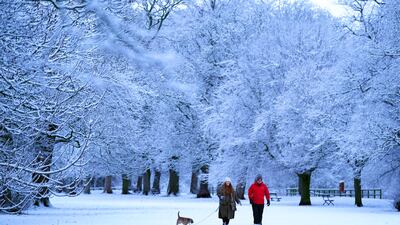 Dog walkers near Hexham, north-eastern England. Drivers have been warned to factor in extra time for their journeys on icy roads. PA