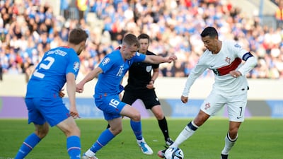 Portugal's Cristiano Ronaldo, right, is challenged by Iceland's Saevar Atli Magnusson. AP Photo