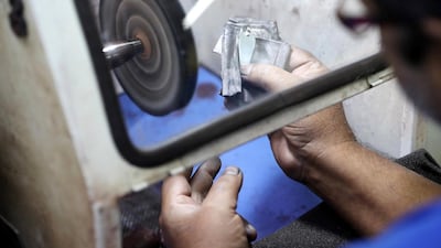 A worker polishes silver jewellery at Al Baroon Gold Factory in Sharjah. Pawan Singh / The National