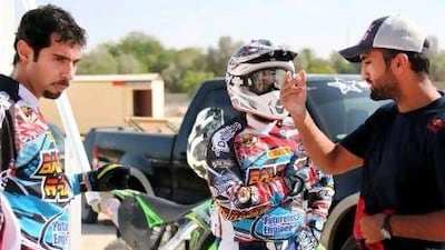 Mohammed Al Balooshi briefs his teammates about the DMX Motocross track.