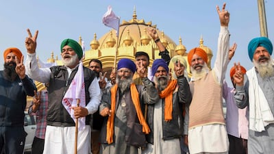 Farmers in Amritsar celebrate after India's prime minister announced the decision to repeal three agricultural reform laws that sparked more than a year of protests across the country. AFP