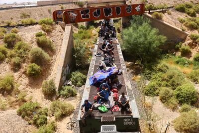 Migrants in Mexico travel on a train headed towards the US border. Reuters
