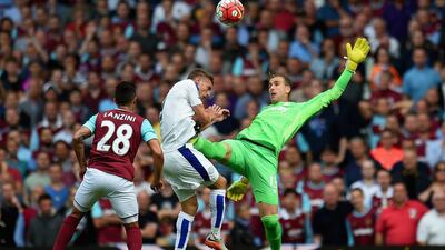 West Ham keeper Adrian tries to clear the ball from Leicester City's Jamie Vardy, planting his boot in Vardy's chest and earning a red card on Saturday during their Premier League contest. Al Jazira player Manuel Lanzini, on loan at West Ham, looks on. Michael Regan / Getty Images