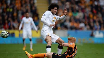 Manchester United’s Belgian midfielder Marouane Fellaini (L) comes in late to foul Hull City’s Irish defender Paul McShane (R) after which Fellaini is shown a straight red card to be sent off during the English Premier League football match between Hull City and Manchester United at the KC Stadium in Kingston upon Hull, north east England on May 24, 2015. AFP PHOTO / OLI SCARFF
