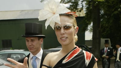 Zara Phillips, wearing a black dress with a floral print, and Richard Johnson attend the first day of Royal Ascot on June 17, 2003. Getty Images