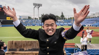 This picture taken on May 13, 2023 shows a member of the Meiji University "Oendan" cheering during a university baseball game at Meiji Jingu Baseball Park in Tokyo. They're drenched in sweat, their hands bloodied from clapping, and their voices hoarse from shouting -- meet Japan's predominantly male and unashamedly macho "leadership section" cheerleaders. (Photo by Yuichi YAMAZAKI / AFP) / To go with "Japan-culture-society-gender", FEATURE by Tomohiro OSAKI