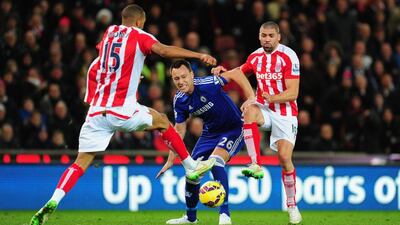 Chelsea player John Terry (c) is challenged by Jonathan Walters (r) and Steven Nzonzi during the Barclays Premier League match between Stoke City and Chelsea at Britannia Stadium on December 22, 2014 in Stoke on Trent, England. (Photo by Stu Forster/Getty Images)