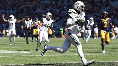 Marcus Kemp, second right, of the Hawaii Rainbow Warriors scores a touchdown during the Sydney Cup NCAA American football game against the California Golden Bears. Paul Miller / EPA