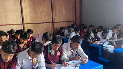 Pupils share benches and desks in temporary school facilities. Photo: Rajendra Dawadi