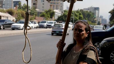 Protesters carry a mock gallows outside a military court during the hearing for Amer Fakhoury in Beirut, Lebanon. Reuters