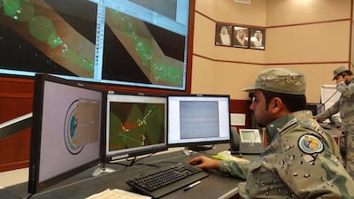 Saudi border guards monitor cameras and radars on surveillance screens at the Arar regional command and control centre headquarters. AFP