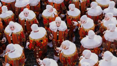 The Gilles of Binche wear traditional wax masks as they attend Carnival celebrations in Binche, Belgium. AP