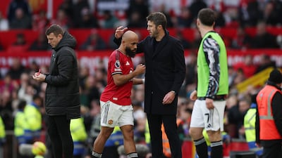 Michael Carrick embraces Bryan Mbeumo. Getty Images