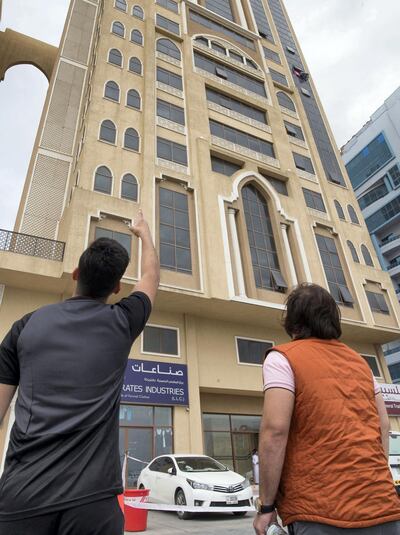Onlookers point at the building in Ras Al Khaimah from which 19-month-old Leen Farghali suffered a horrific fall. Leslie Pableo for The National