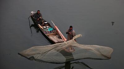 A fisherman casts his net in the waters of a flood channel on the outskirts of Srinagar. Danish Ismail / Reuters