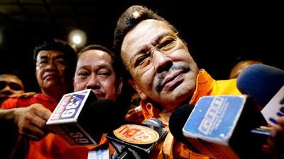 Joseph Estrada, the new mayor of Manila, celebrates his victory with reporters. Bullit Marquez / AP Photo