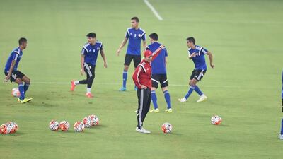 UAE national team coach Mahdi Ali, in red, directs his players during a training session ahead of 2018 World Cup qualifying matches against Palestine and Malaysia in the next week. Photo Courtesy / UAE FA