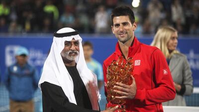 Novak Djokovic accepts the first place trophy from Sheikh Mubarak Al Nahyan Mubadala Tennis Championships at Zayed Sports City. Lee Hoagland / The National