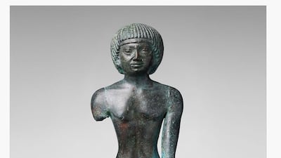 A bronze statue depicting a man kneeling.