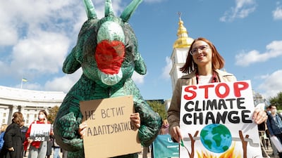 Environmental activists take part in a rally demanding actions to avert climate change in central Kyiv, Ukraine September 26, 2021. More than 600 business leaders around the world are calling on G20 countries to take more decisive climate change action. Reuters