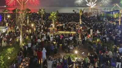 Crowds watch in awe as fireworks explode over The Beach to celebrate the UAE’s 43rd National Day in Dubai. Sarah Dea / The National
