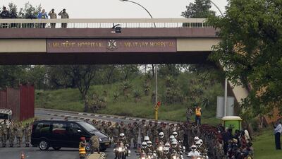 Defense force personnel and hospital staff salute the procession for former South African president Nelson Mandela as it leaves the military hospital in Pretoria. Themba Hadebe / AP Photo