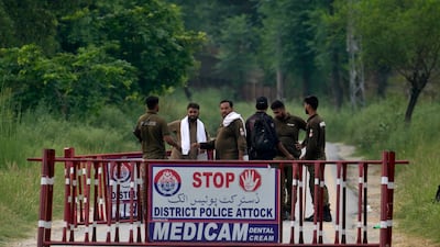 Police officers barricade a road leading to Attock prison, where Imran Khan is being held. AP