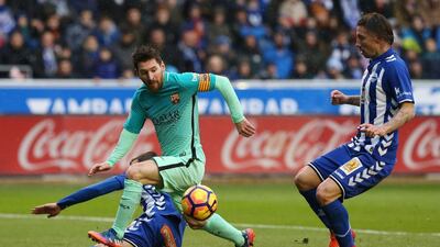 Barcelona’s Lionel Messi, left, vies with Alaves’ French defender Theo Hernandez. Cesar Manso / AFP