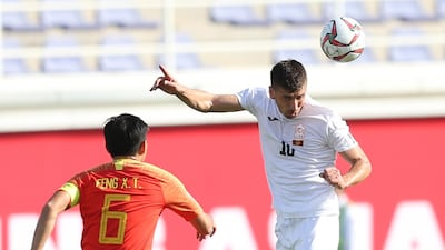 Kyrgyzstan's Murzaev Mirlan gets a header away. EPA