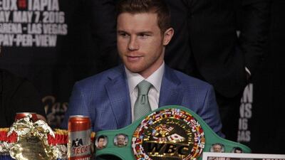 Saul Alvarez looks on as England’s Amir Khan speaks during their final press conference. John Gurzinski / AFP