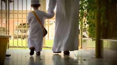 A screengrab from a video released by Ras Al Khaimah Police showing an inmate having been released to take his son to school on the first day of the new academic year. Courtesy RAK Police