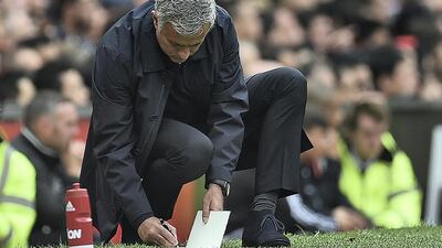 Jose Mourinho makes notes on the touchline during the Premier League match between Manchester United and Manchester City at Old Trafford on September 10, 2016. AFP