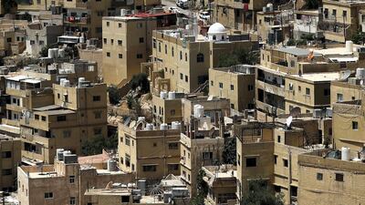 A general view taken from Jabal Al Qala district shows a Jordanian flag fluttering above the Jordanian capital Amman. AFP