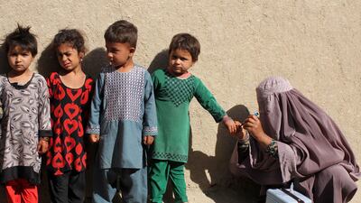 A health worker marks the finger of a child after administering polio vaccination to children in Kandahar, Afghanistan, in April 2019. Muhammad Sadiw / EPA