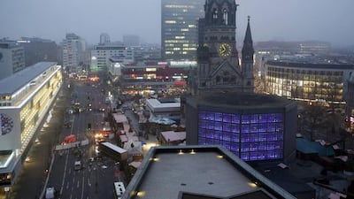 A tow truck operates at the scene where a lorry ploughed through a crowd at a Christmas market. Fabrizio Bensch / Reuters