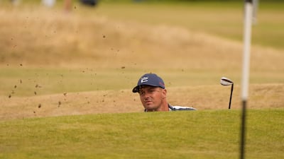 Bryson DeChambeau of the US hits out of a bunker on to the 17th green. He finished the day with a round of 69 for three under par. AP