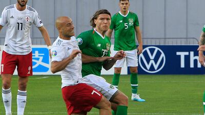 Ireland's Jeff Hendrick, right, fights for the ball with Jaba Kankava of Georgia. AP