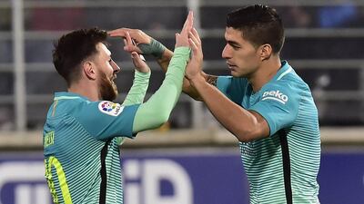 Lionel Messi celebrates with Luis Suarez after the Uruguayan forward set up his goal to give Barcelona a 2-0 lead in their 4-0 victory over Eibar on Sunday. Alvaro Barrientos / AP Photo