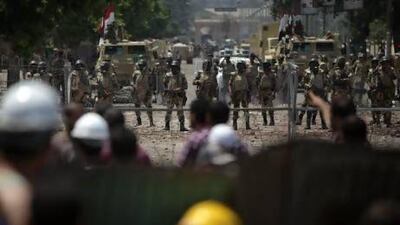 Egyptian soldiers stand guard around the Republican Guard building in Nasser City, Cairo.