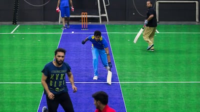 A group of men play indoor cricket at the Insportz Club in the Al Quoz area of Dubai. Christopher Pike / The National